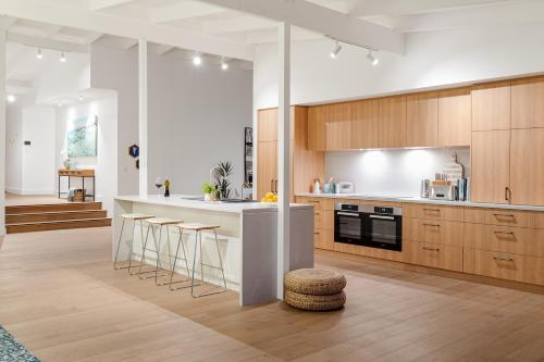 a kitchen with wooden cabinets and a white counter top at The View, Albany Holiday House in Albany