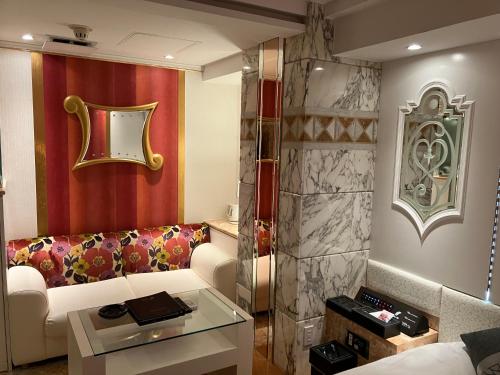 a living room with a couch and a table at HOTEL PAL Otsuka -Adult Only- in Tokyo