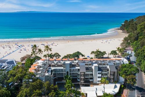 an aerial view of a beach with people on it at 71 Hastings - Beachfront in Noosa Heads