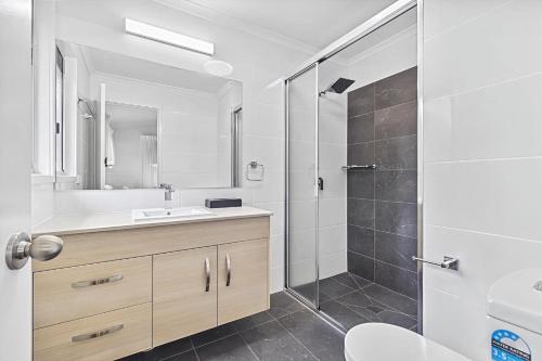 a bathroom with a sink and a shower at Ingenia Holidays Cairns Coconut in Cairns