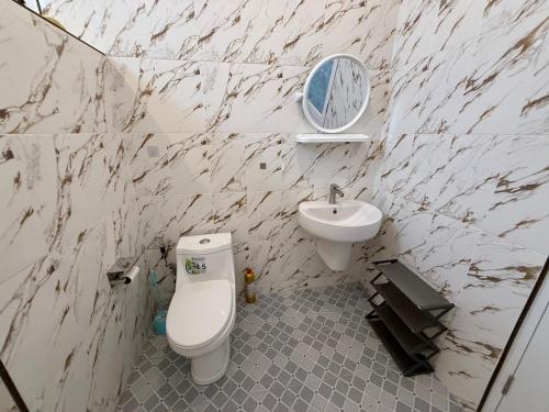 a bathroom with a sink and a toilet and a mirror at Very Central Boho Home in Srithanu in Ko Kong Nui