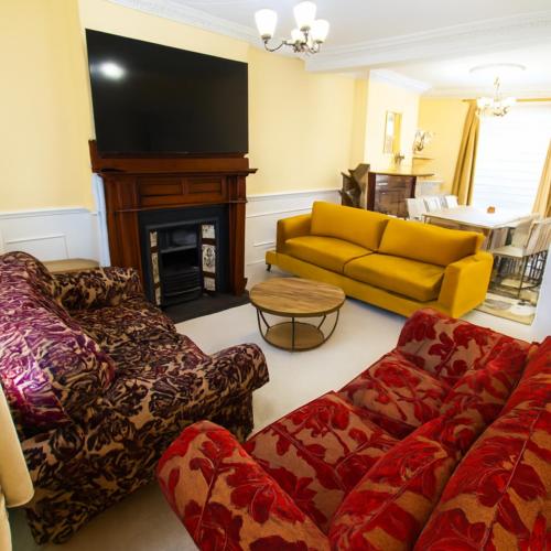 a living room with a couch and a fire place at Spacious 3 Bedroom Property, Sleeps 8, Perfect for Business & Leisure in South East London in London