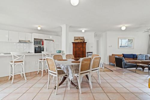 a kitchen and living room with a table and chairs at Shelly Vista in East Ballina