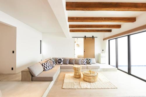 a living room with a couch and a table at Grand Bleu Gamin in Miyako-jima