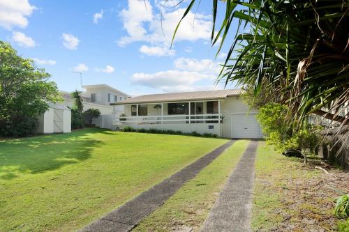 a house with a large yard in front of it at Baileys Beach House in East Ballina