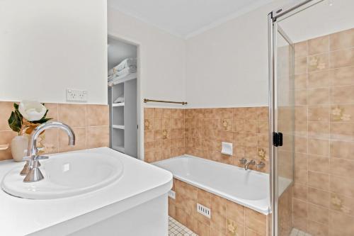a bathroom with a sink and a shower at Sun Soaked Lennox Village in Lennox Head