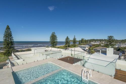 an overhead view of a swimming pool with the beach at Wintersview 2 in Lennox Head