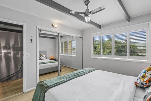 a bedroom with a bed and a ceiling fan at Stingray in Ballina