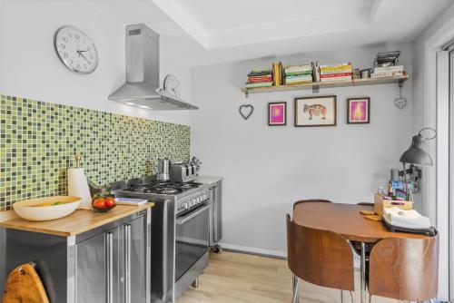 a kitchen with a table and a stove and a counter top at Stingray in Ballina