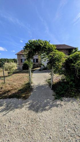 a house with two trees in front of it at La parenthèse bucolique in Cheissoux
