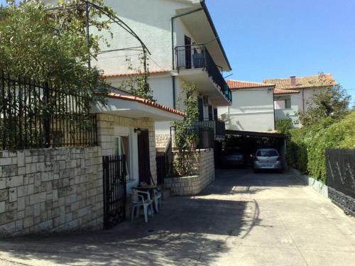 a house with a car parked in the driveway at Apartments Kolorček in Izola