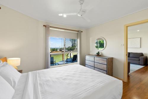 a bedroom with a large white bed and a window at Haere Mai 2 in East Ballina