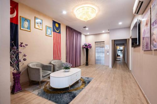 a living room with a couch and a coffee table at Lavender Inn Permas Jaya in Johor Bahru
