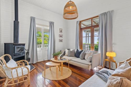 a living room with a couch and a fireplace at Hinterland Views in Lennox Head