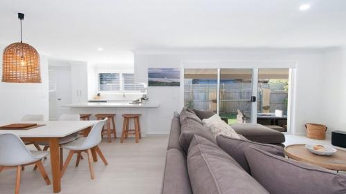 a living room with a couch and a table at Kay s Hideaway in Lennox Head