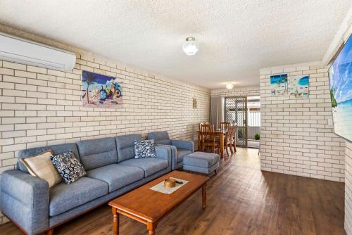 a living room with a couch and a table at Kenway Lodge in Ballina