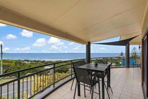a balcony with a table and chairs and the ocean at Oceanic 3 in East Ballina