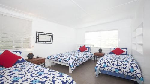 a bedroom with two beds and two windows at My Blue Heaven Dog Friendly in Lennox Head
