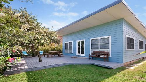 a blue house with a picnic table and a patio at My Blue Heaven Dog Friendly in Lennox Head