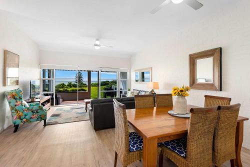 a living room with a table and a couch at Quarterdeck 18 in Lennox Head