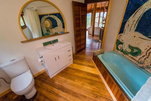 a bathroom with a tub and a toilet and a sink at The Roundhouse in Jackeys Marsh