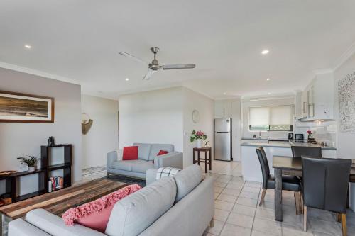 a living room with a couch and a table at Surf Sea and Sand in East Ballina
