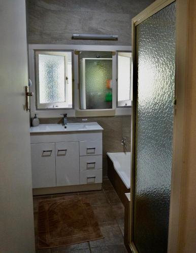 a bathroom with a sink and a mirror and a shower at "Mansfield" Cottage Barrington - Quality Holidays for over 25 Years in Barrington