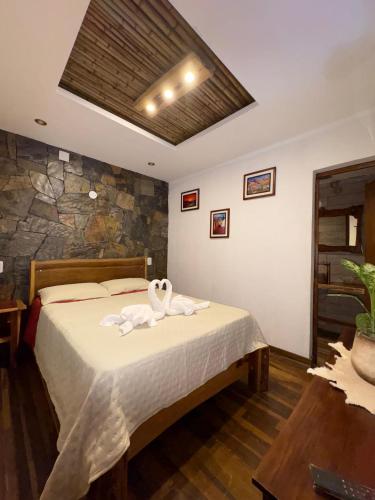 a bedroom with a bed with towels on it at Casa Nuna in Tilcara