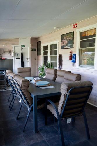 a dining room with a table and a couch at "Mansfield" Cottage Barrington - Quality Holidays for over 25 Years in Barrington
