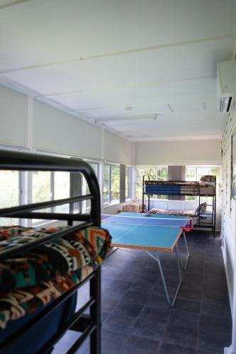 a room with a ping pong table and bunk beds at "Mansfield" Cottage Barrington - Quality Holidays for over 25 Years in Barrington