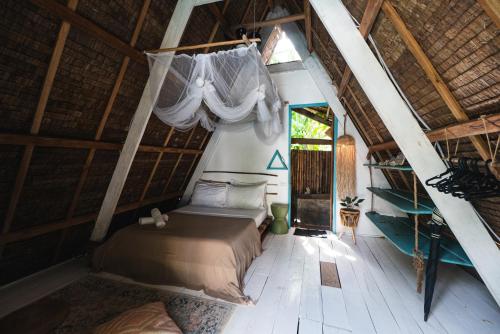 a bedroom with a bed in a room with a attic at Mao Mao surf in General Luna