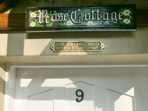 a sign above the front door at Rose Cottage - Uk34067 in Grassington