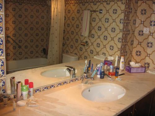 a bathroom with a sink and a mirror at Farmhouse in Montemor near Forest and Lake in Montemor-o-Novo