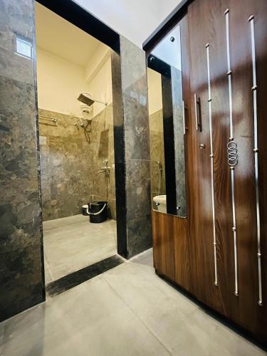 a bathroom with a shower and a toilet and a sink at villa Belmond with private pool in Udaipur