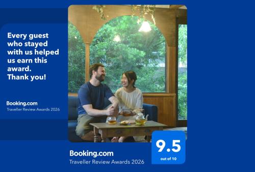 a man and a woman sitting at a table at 野窓 Nomadノマド Tsuwano GuestHouse & Cafe Lounge in Tsuwano