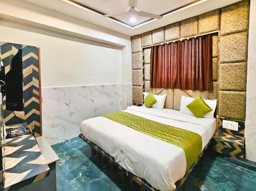 a bedroom with a bed in a room at Hotel Karnavati Motera Ahmedabad in Ahmedabad