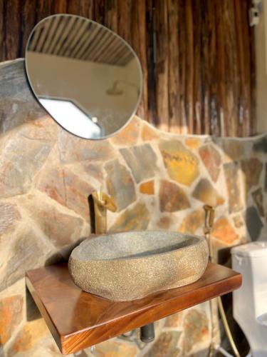 a bathroom with a stone sink and a mirror at Romantic - second floor - large balcony - bathtub in Vũ Lâm