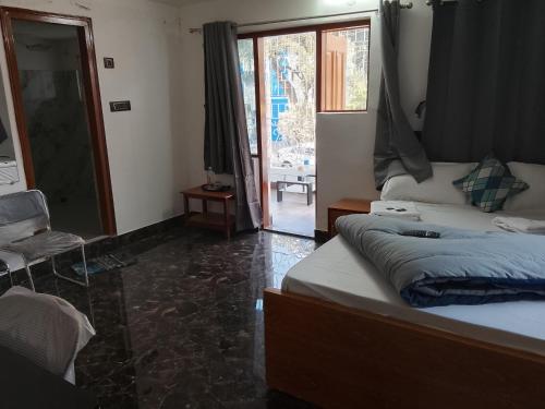 a bedroom with a bed and a door to a patio at PlatinumIN Guesthouse in kolkata