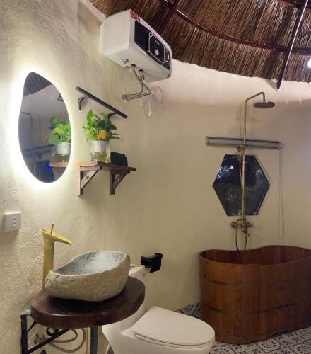 a bathroom with a sink and a toilet and a tub at Charming - attractive - pristine nature - peaceful in Vũ Lâm