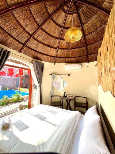 a bedroom with a bed and a wooden ceiling at Charming - attractive - pristine nature - peaceful in Vũ Lâm