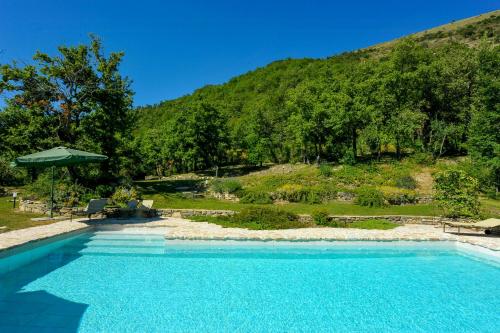 a swimming pool in front of a mountain at Villa With Private Pool In Umbria in Umbertide