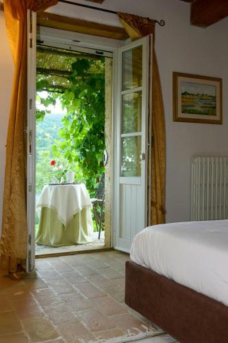 a bedroom with an open door with a table with a table cloth at Villa With Private Pool In Umbria in Umbertide