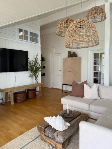a living room with a couch and a table at Northern Lights View Cabin With Big Veranda in Ballangen