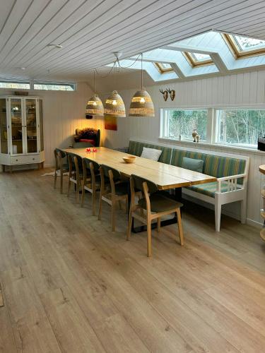 a dining room with a table and chairs and a couch at Hidden Gem By Thy National Park in Bedsted