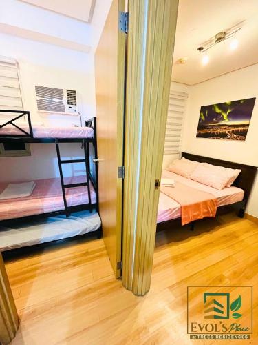 a room with two bunk beds in it at Trees Residences Staycation 2 Bedroom in Manila