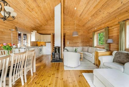a kitchen and living room in a log cabin at Cabin With Jacuzzi And Stream In Krågeland in Kvinlog