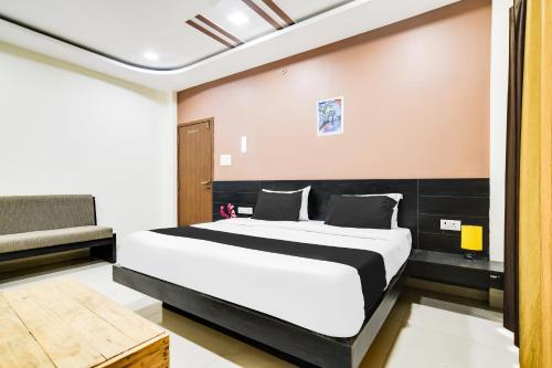a bedroom with a large bed in a room at Super Collection O Indore Near Omax City 1 in Kanāria