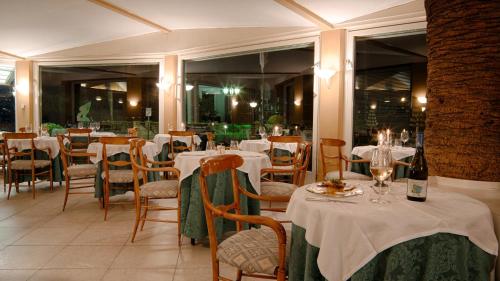 a restaurant with tables and chairs with white table cloth at Best Western Regina Elena in Santa Margherita Ligure