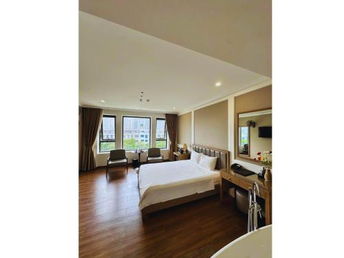 a hotel room with a bed and a bathroom at Nhật Tân Hotel Hà Nội - Lê Trọng Tấn in Hanoi