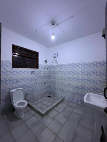 a bathroom with a toilet and a sink at GMW Sanduni hotel & villa in Matara